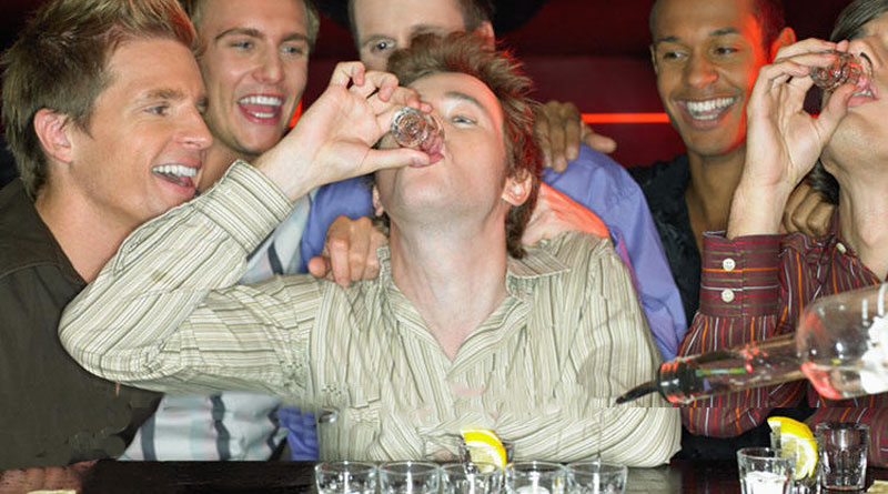men drinking shots at bachelor party